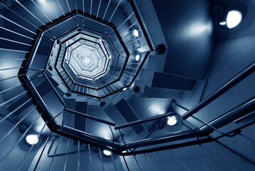 Interior view of modern spiral stairway. Building abstract background