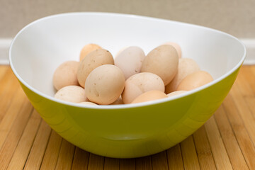 fresh unwashed rustic eggs lie in a deep bowl