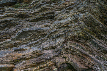 Granite rock wall texture. Mountain stone geological layers