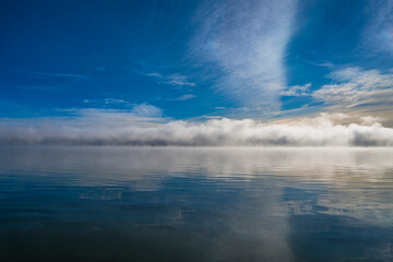 Morning fog, foggy clouds on blue lake