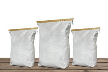 Paper bags set on wooden floor. Construction plaster cement sack isolated on white