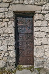 Old rusty iron door of medieval stone castle