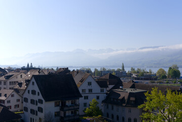 Aerial view of the old town of City of Rapperswil with Swiss Alps in the background on a sunny spring day. Photo taken April 28th, 2022, Rapperswil-Jona, Switzerland.