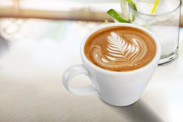Hot aroma cup of coffee on desk board
