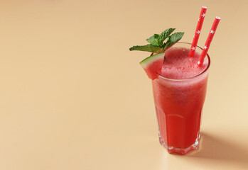 Watermelon smoothie with mint on beige background with place for text