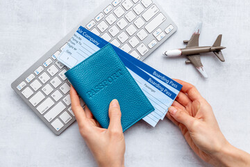 Hands holding passport with tickets - traveler concept