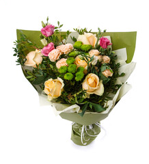 Mixed floral arrangement wrapped in kraft paper on white background.