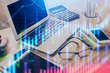 Forex market graph hologram and personal computer on background. Multi exposure. Concept of investment.