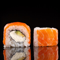 Sliced sushi Philadelphia on black background. Food and restaurants.