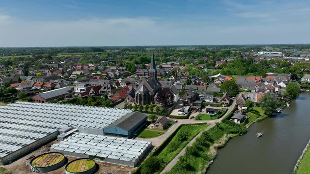 The Dutch town of Beesd from the air with its characteristic stubby tower and windmill De Vrijheid