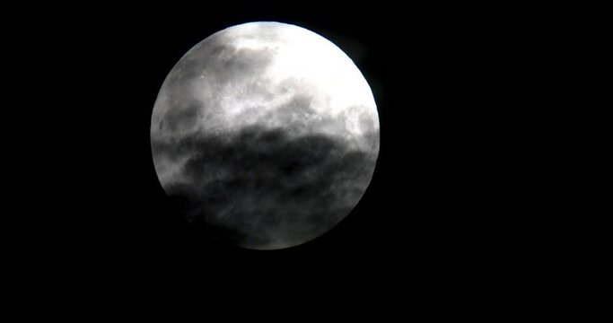 A full moon on a cloudy day