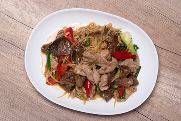 Stir-fried pork with ginger in a white plate on a white background