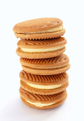 Custard cream sandwich biscuits on white background.