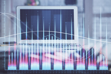 Forex market graph hologram and personal computer on background. Multi exposure. Concept of investment.