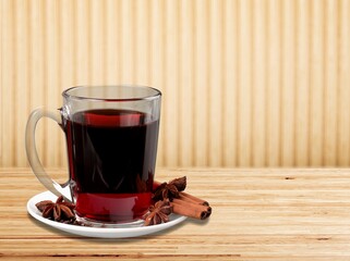 The concept of ceremony. Red tea in a cup. Desk background.