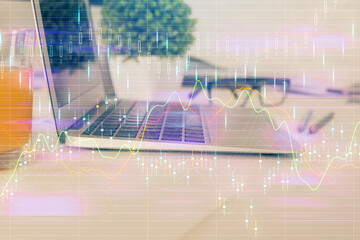 Forex market graph hologram and personal computer on background. Multi exposure. Concept of investment.