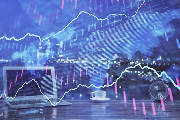 Forex market graph hologram and personal computer on background. Multi exposure. Concept of investment.