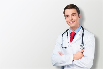 Fototapeta premium Happy young doctor in a white coat posing