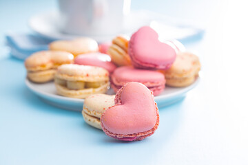 Fototapeta premium Heart shaped Sweet macarons on blue table.