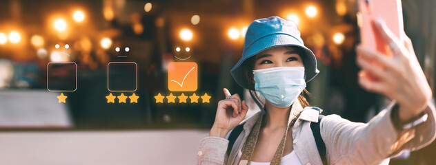 Young adult asian woman travel wear face mask in customer review rating five star service