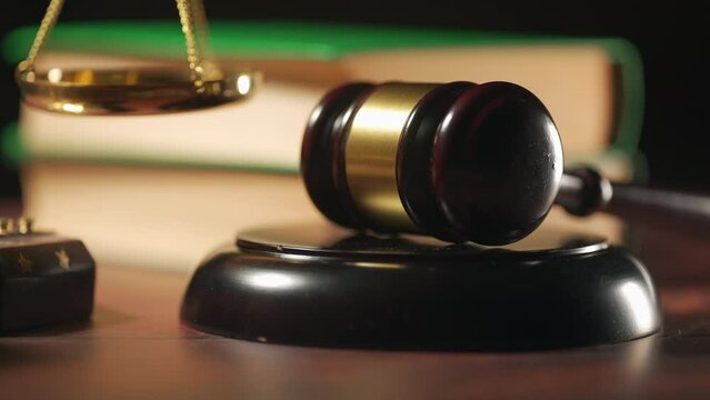 Close up of a judge gavel and a scales of justice. Legal lawyer books or codex. Concept of law or legal system and jurisprudence or court.