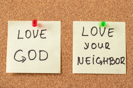 Love God, love your neighbor, handwritten notes on a pinning board. The biblical concept of Christian faith and obedience to Jesus Christ, the greatest commandment from Bible. Top view, a close-up.