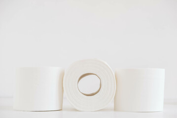 Rolls of white toilet paper on a white background