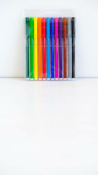 Multicolored felt-tip pens in a transparent package on a white background