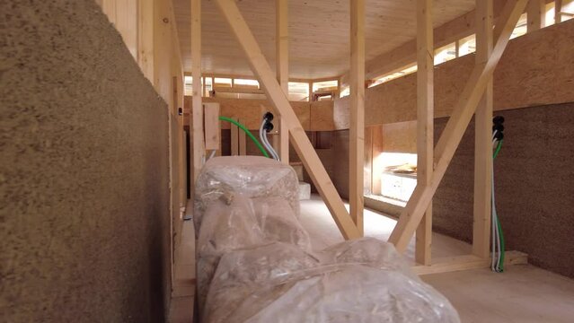 Slowly panning horizontally into a hempcrete wall in a contruction site