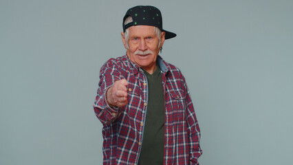 Friendly senior old man outstretching hand to camera, offering handshake, greeting with kind smile, welcoming showing solidarity, trust concept. Elderly grandfather isolated on gray studio background