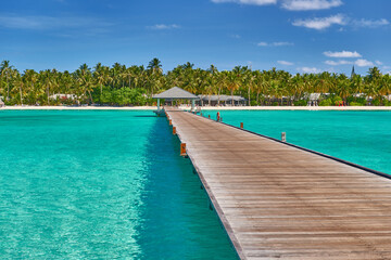 Fototapeta na wymiar Maldives paradise scenery. Tropical aerial landscape, seascape with long jetty, water villas with amazing sea and lagoon beach, tropical nature. Exotic tourism destination banner, summer vacation