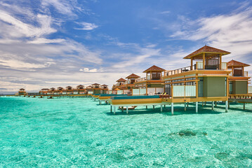 Maldives paradise scenery. Tropical aerial landscape, seascape with long jetty, water villas with amazing sea and lagoon beach, tropical nature. Exotic tourism destination banner, summer vacation