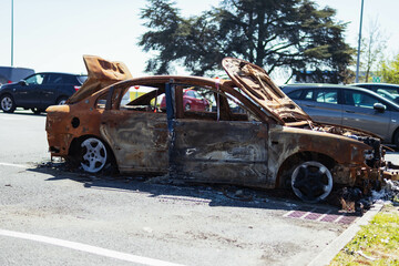 The car after the fire. Iron parts of a burnt car. - obrazy, fototapety, plakaty