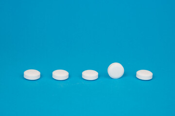White pills antibiotic round on blue background