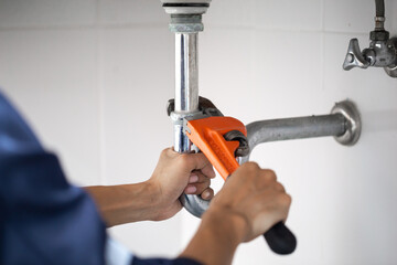 plumber at work in a bathroom, plumbing repair service, assemble and install concept. - obrazy, fototapety, plakaty