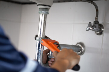 plumber at work in a bathroom, plumbing repair service, assemble and install concept.