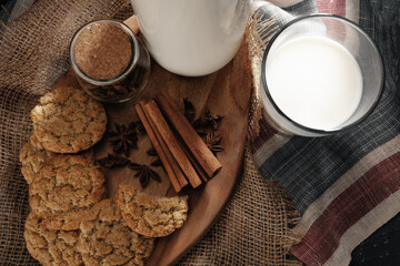 Glass of milk and cookies on table
