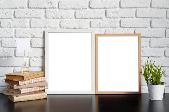 Books with picture frame on wooden table