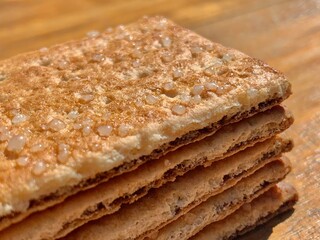 Stacks of the crunchy crisp bread biscuits with granulated sugar on the wood table with closeup shot and natural lighting