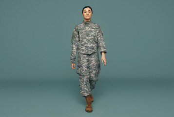 Young American servicewoman marching in a studio