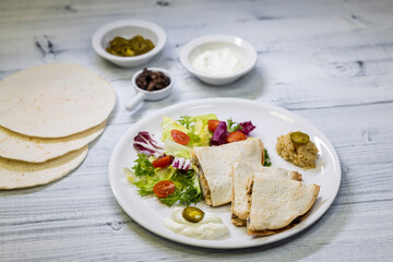 chicken quesadilla with rice, beans, salad, chalapenos and salsa