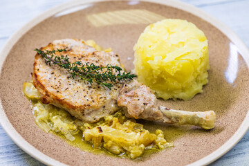 pork chop with thyme baked on creamy onion with mashed potatoes