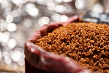 Sack full of brown rice in a market for sale