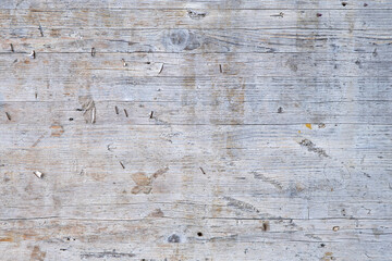 Old weathered wooden board with rusted staples