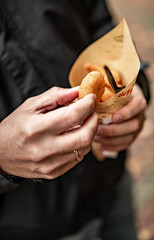 man hand holding Street food fried shrimp