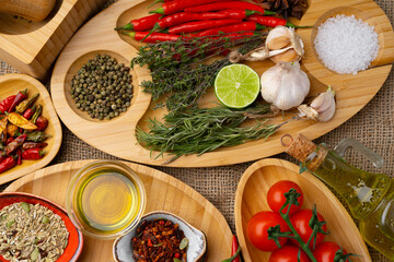 Close up of wooden board with spices, herbs and cooking ingredients