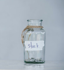 Glass jar with coins placed on white background isolated concept for saving money to keep in reserve for emergency expenses.