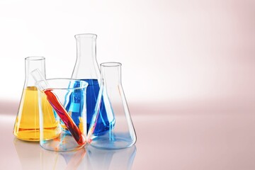 Glass laboratory equipment filled with fluid in a beaker test tube in lab background for experiment advertising