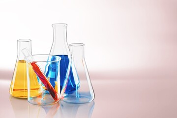Glass laboratory equipment filled with fluid in a beaker test tube in lab background for experiment...