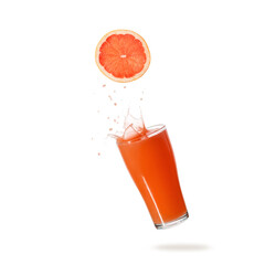 Grapefruit fruit slice and juice glass with splash and drops flying falling isolated on white background.